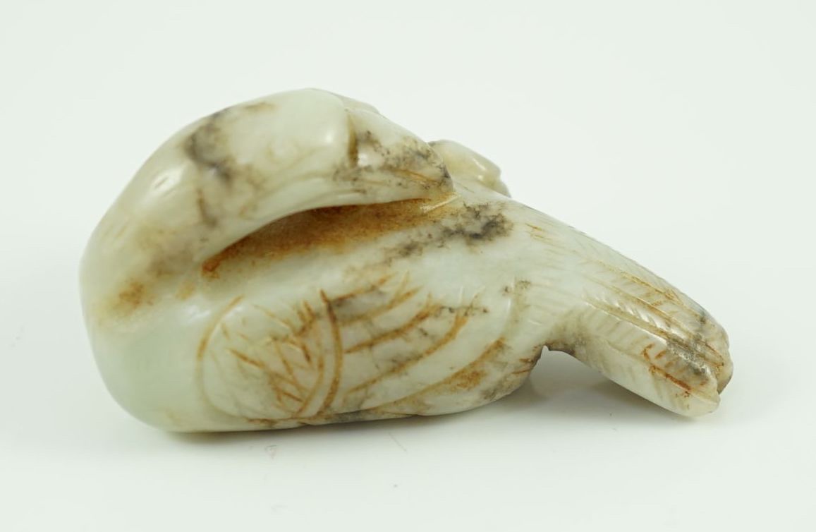 A Chinese white and black jade figure of a preening duck, Ming dynasty, 5.8 cm long